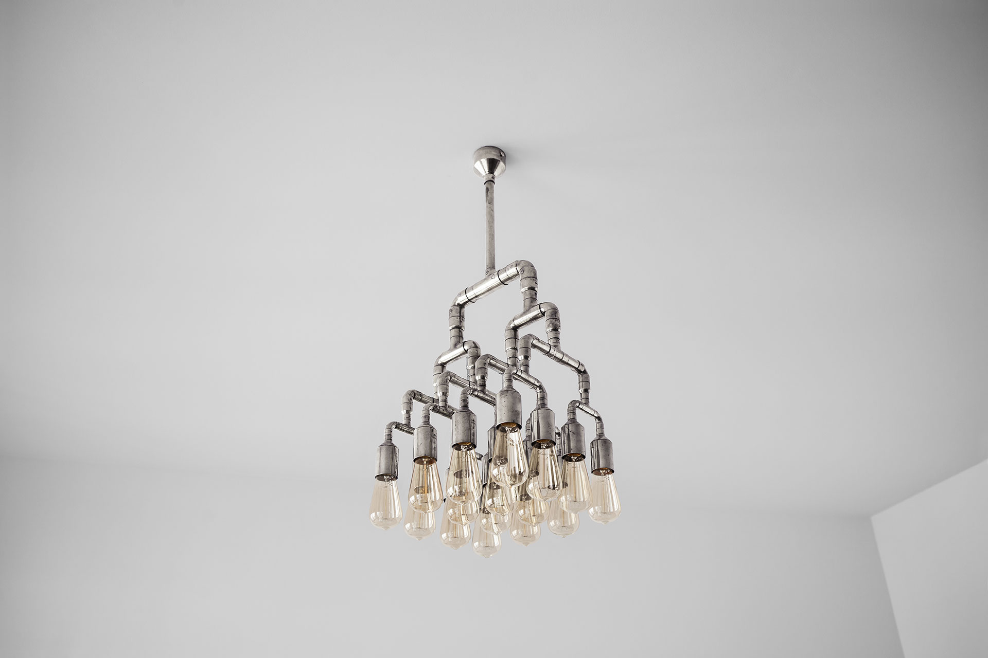 Designer lighting chandelier in silver nickel plated color inspired by industrial and steampunk style