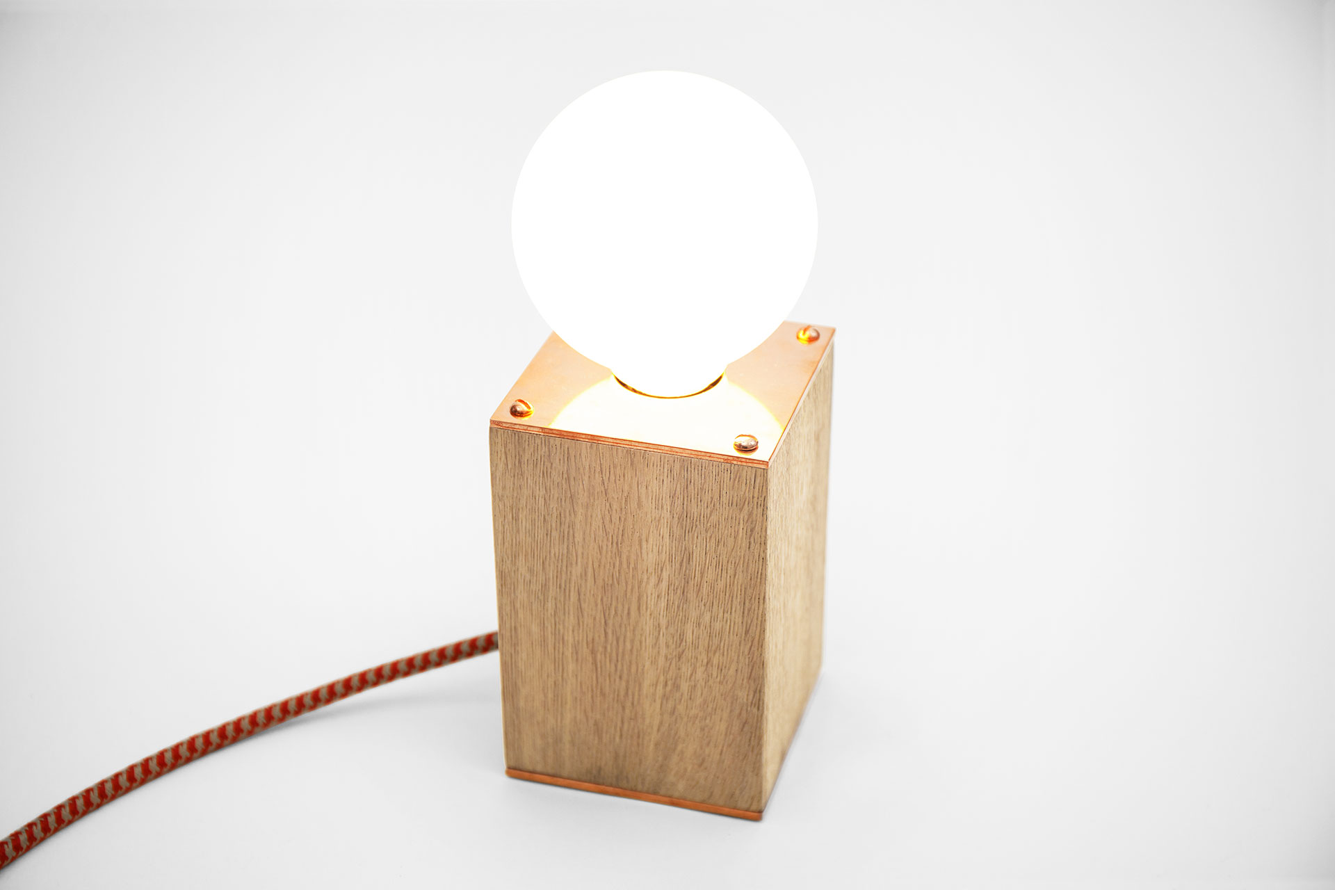 Wooden table lamp with trendy copper details and creative touch dimmer in cozy chic bedroom