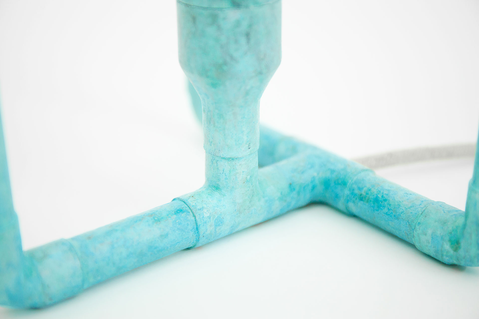 Detail of the colorful table lamp in natural turquoise patina