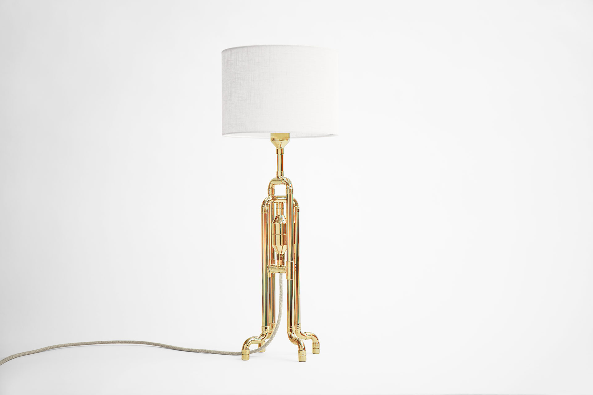 Designer table lamp in gold brass metal finish with white natural linen shade inspired by jellyfish shape