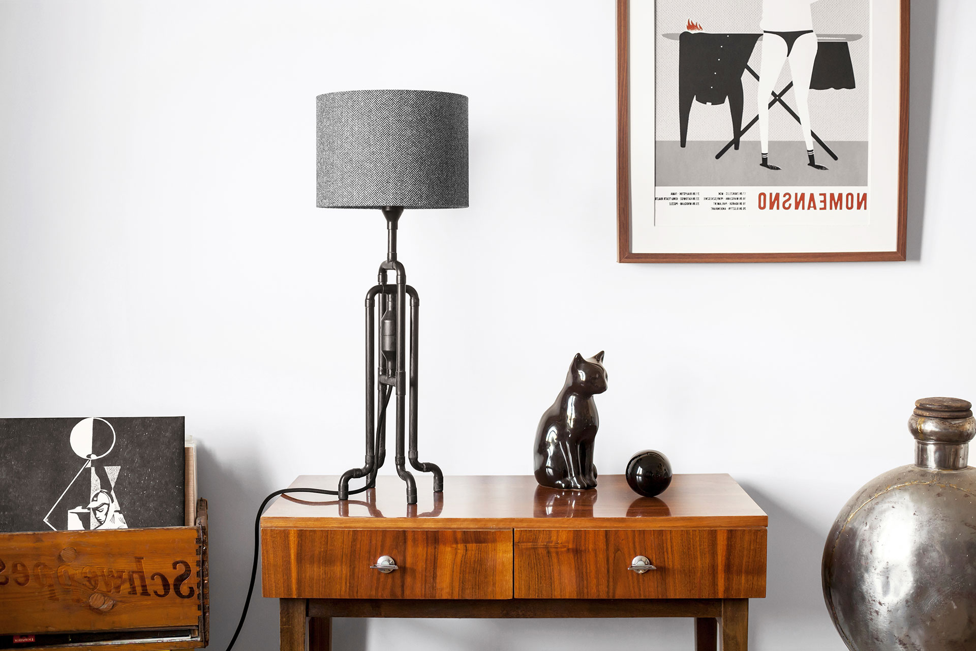 Industrial design table lamp in natural black patina with custom tweed shade in mid-century modern apartment