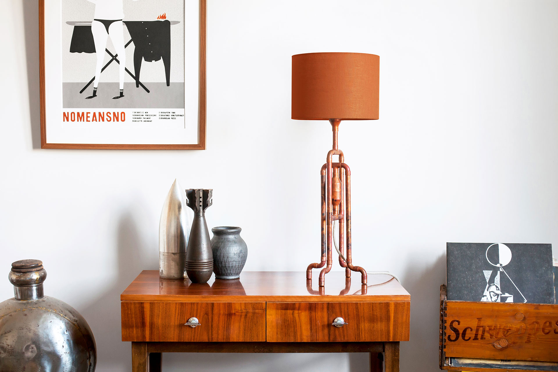 Rust metal table lamp with copper color linen shade in vintage modern apartment
