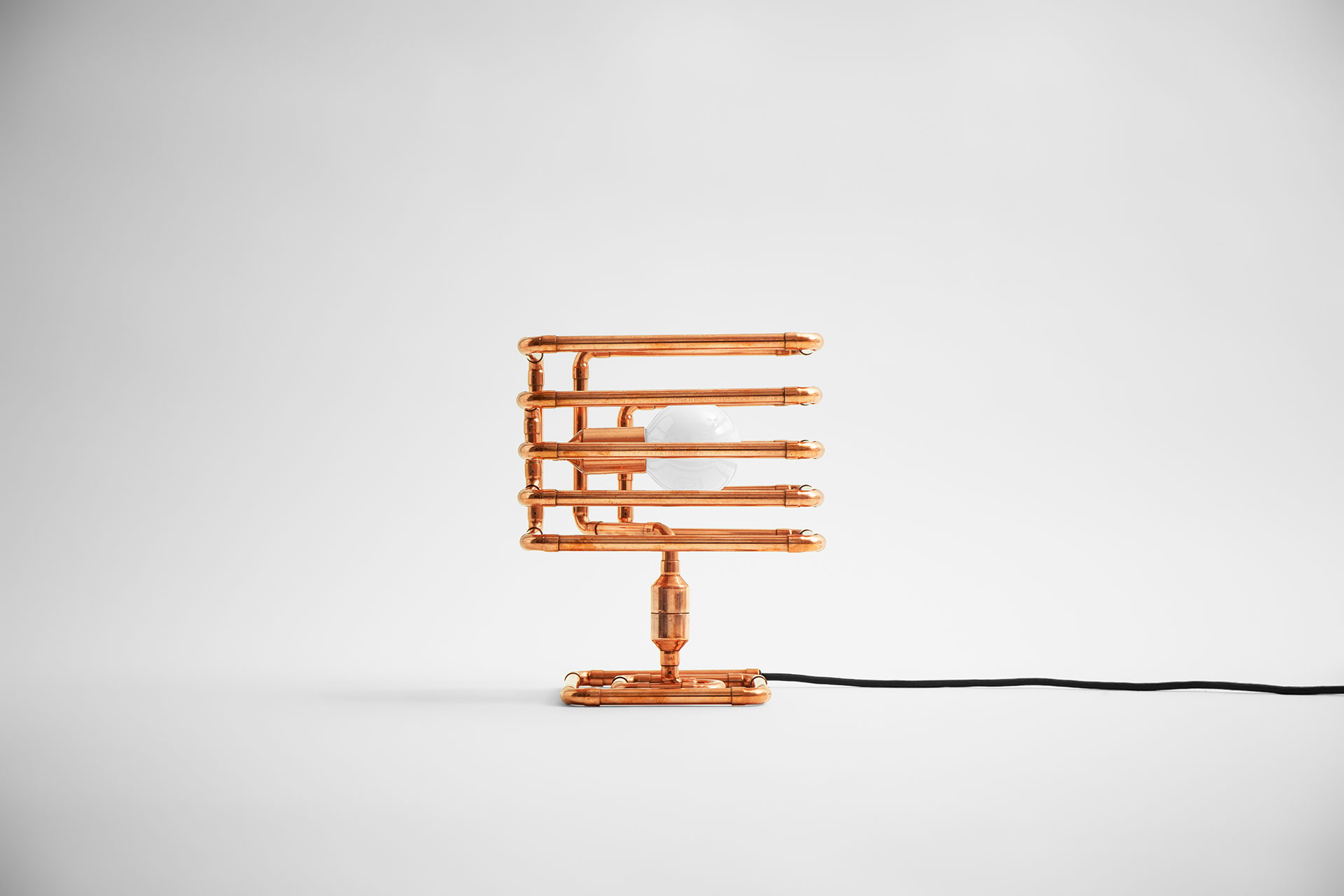 Unusual table lamp in trendy copper metal finish inspired by industrial design