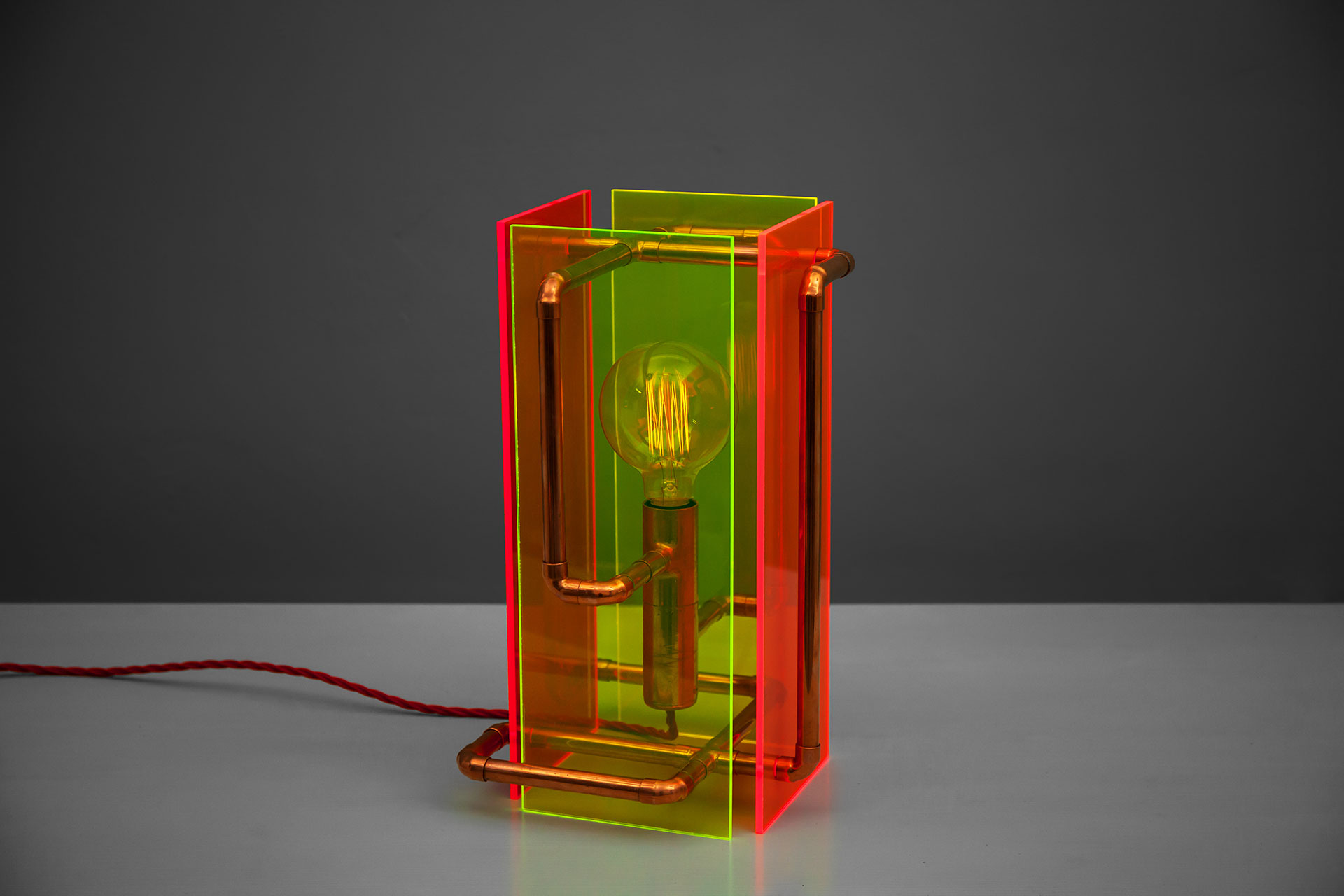 Contemporary ighting design made of fluorescent plexiglass and copper pipes with touch dimmer