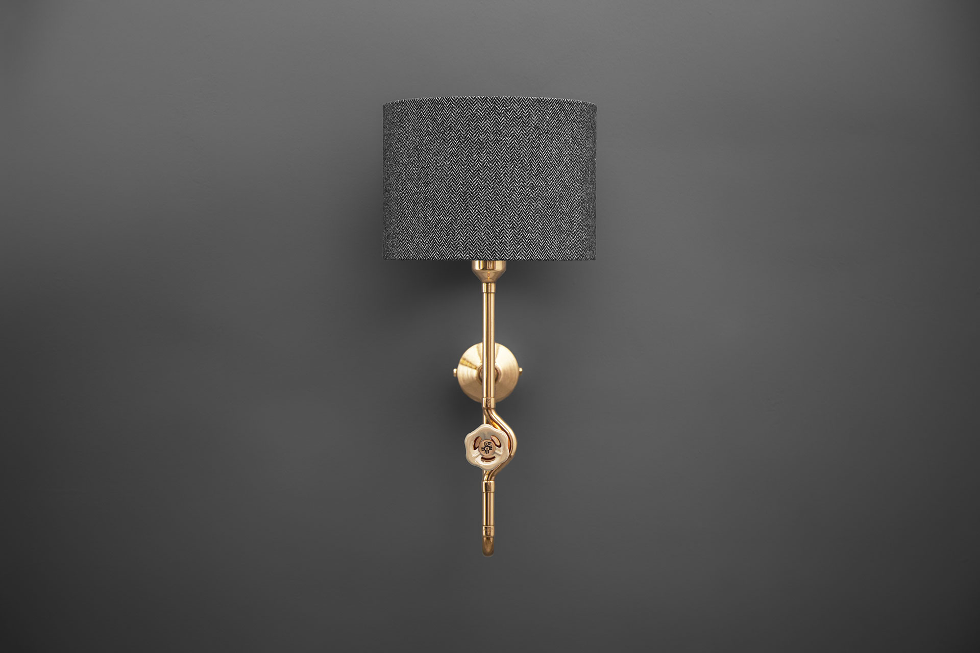 Designers sconce with tweed shade and knob dimmer