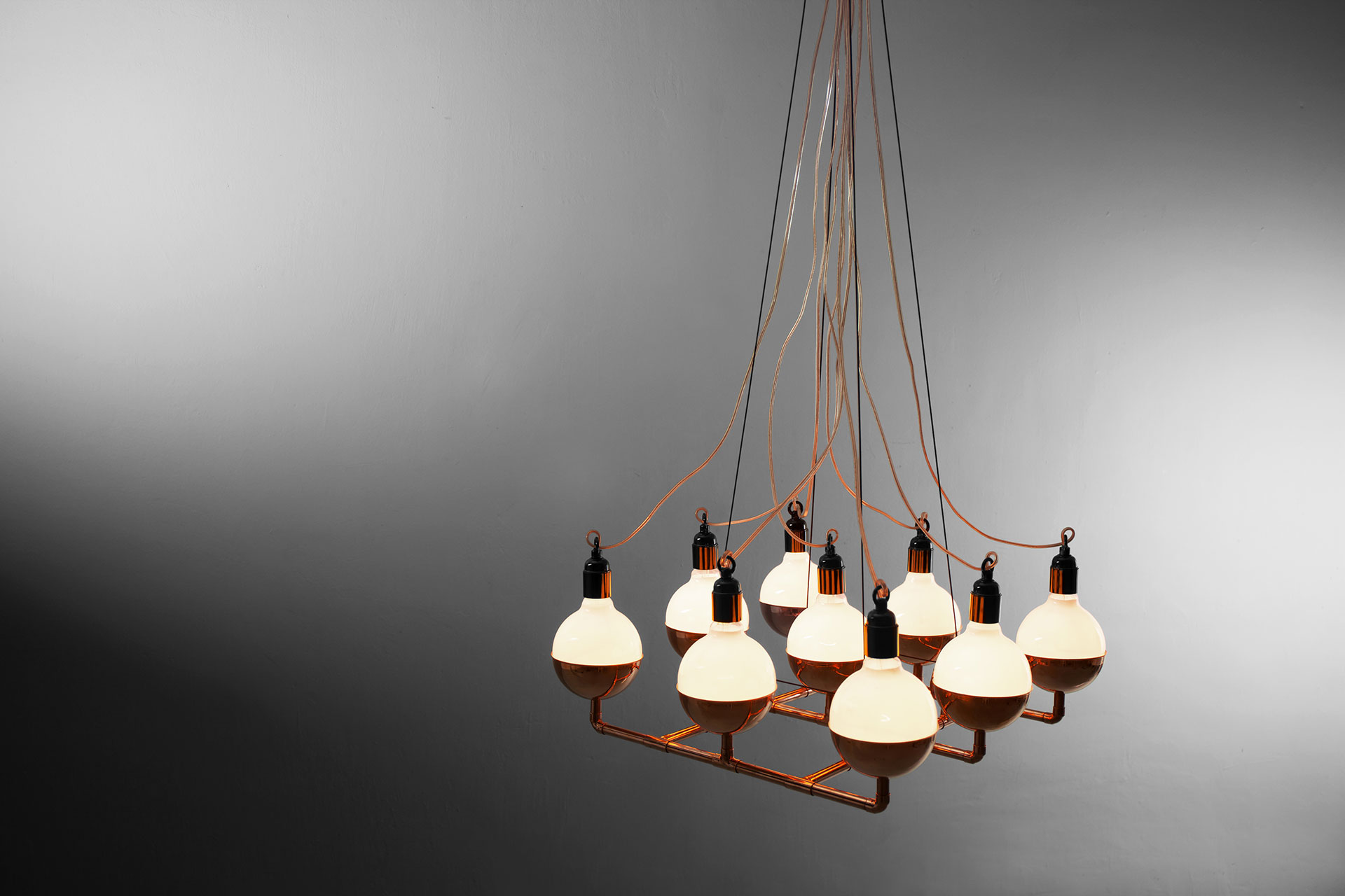 Designer lighting chandelier in trendy copper or brass inspired by cyberpunk style