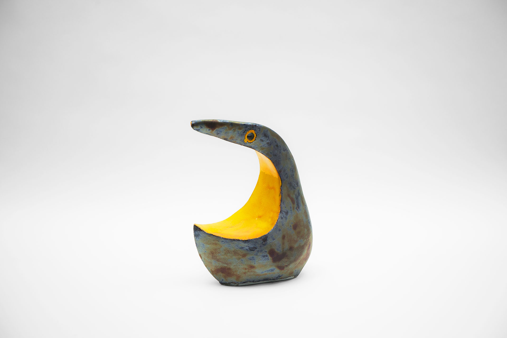 Brutalist design ceramic bird sculpture in blue and yellow color