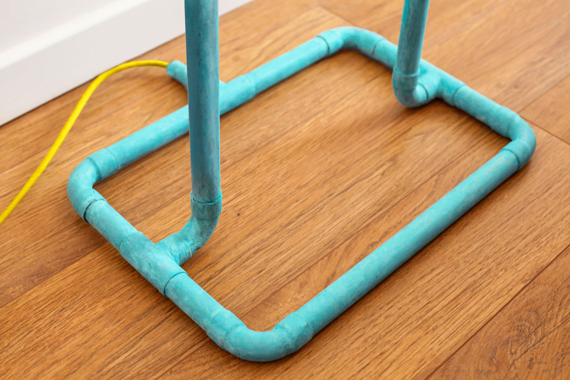 Colorful design floor lamp in turquoise patina with yellow braided cord