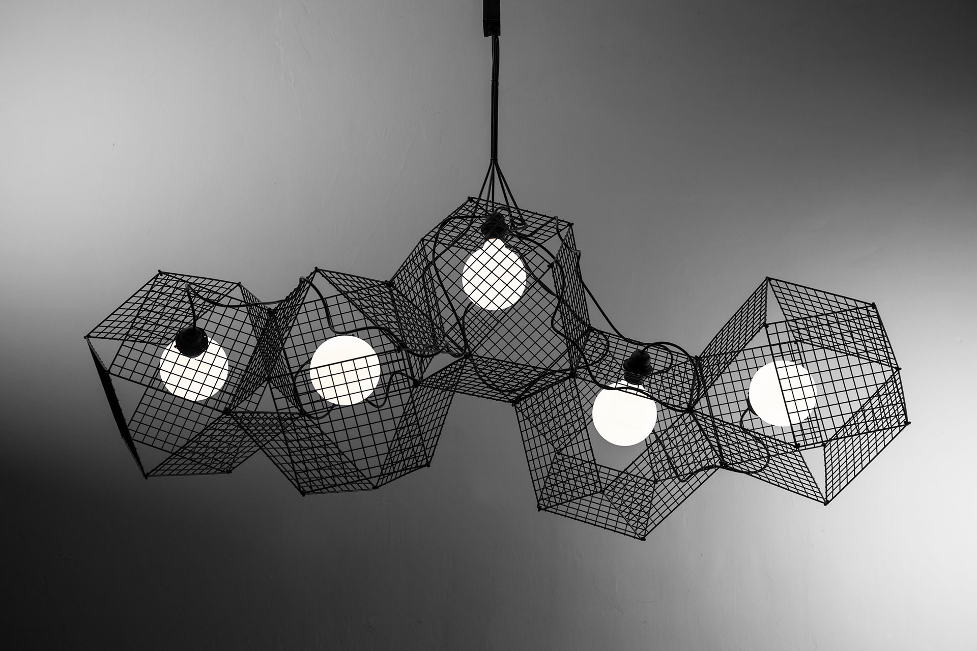 Large designer lighting chandelier in black metal inspired by geometric forms