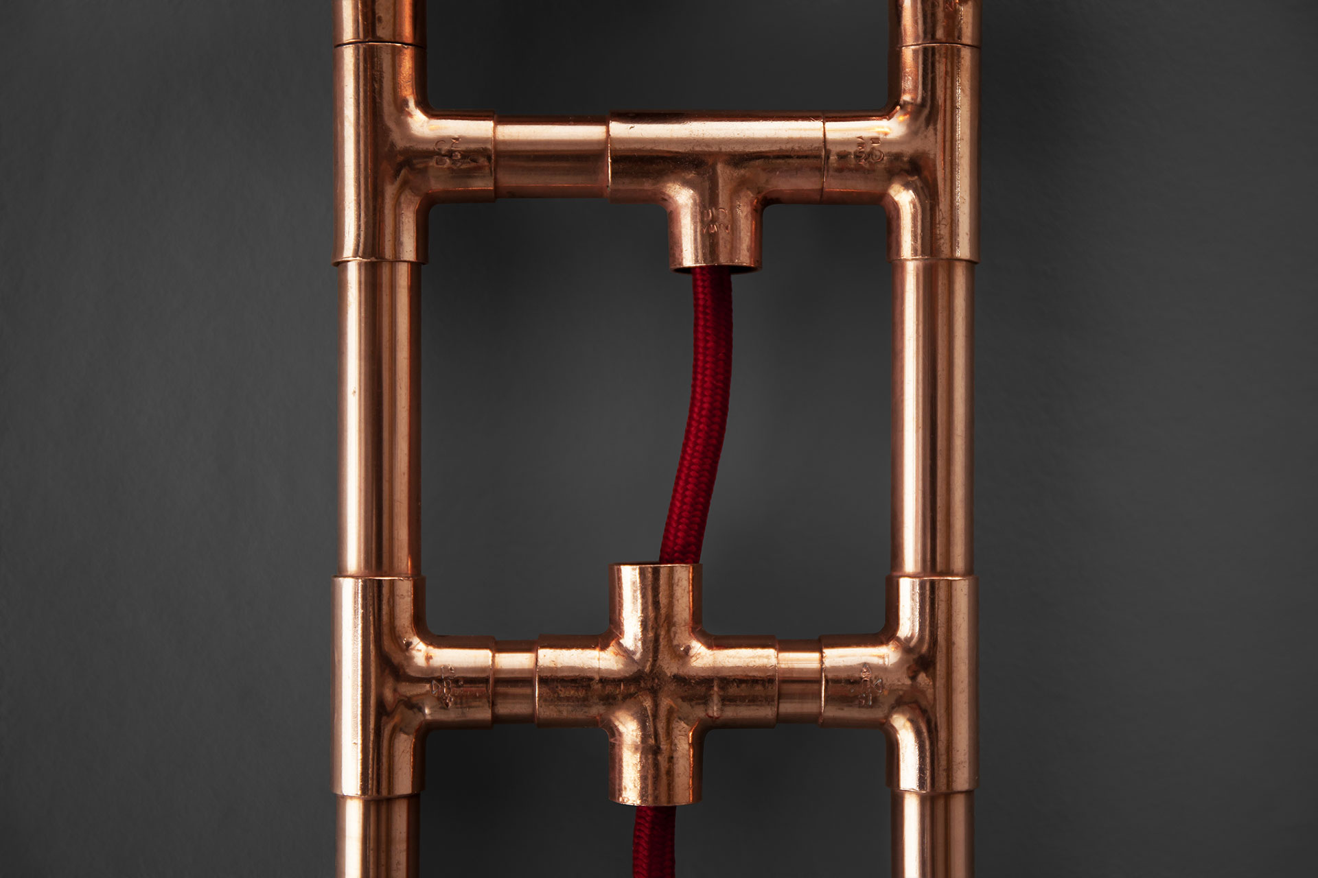Copper pipe wall lamp with red cord