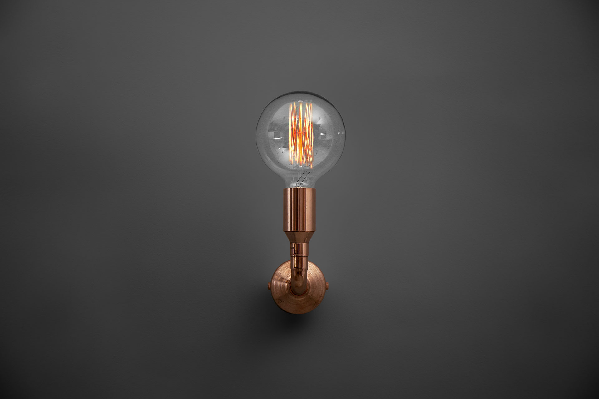 Industrial design copper sconce with vintage Edison bulb