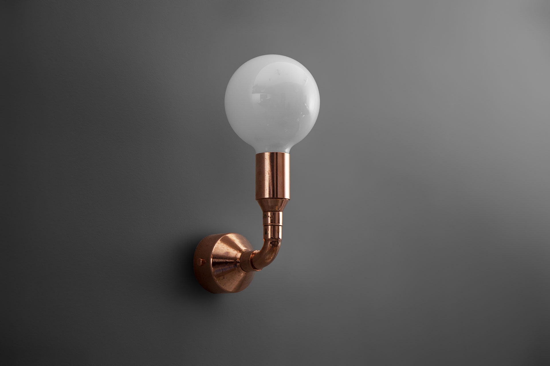 Copper pipe wall lamp in industrial design interior