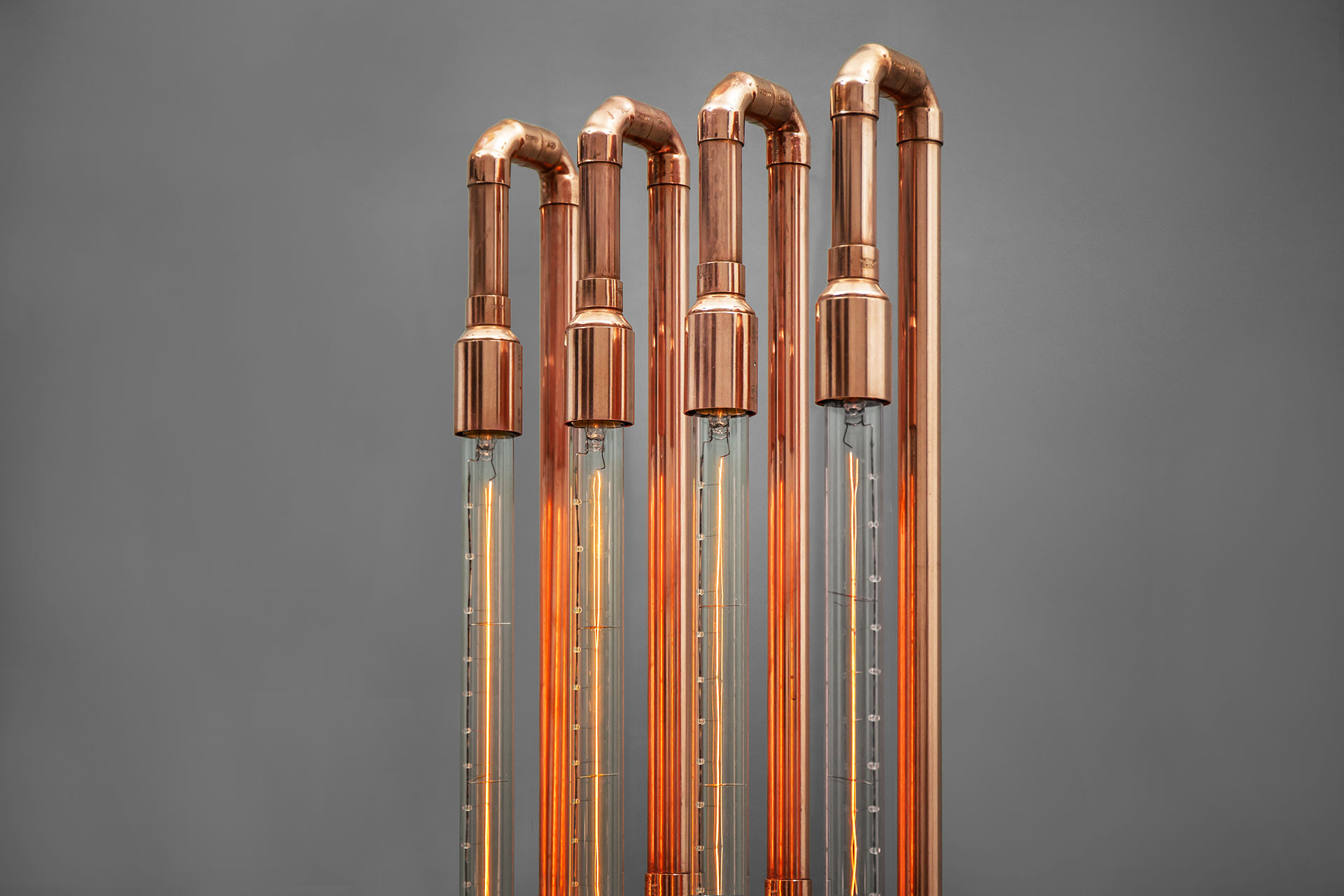 Long Edison bulbs in copper floor lamp inspired by industrial design
