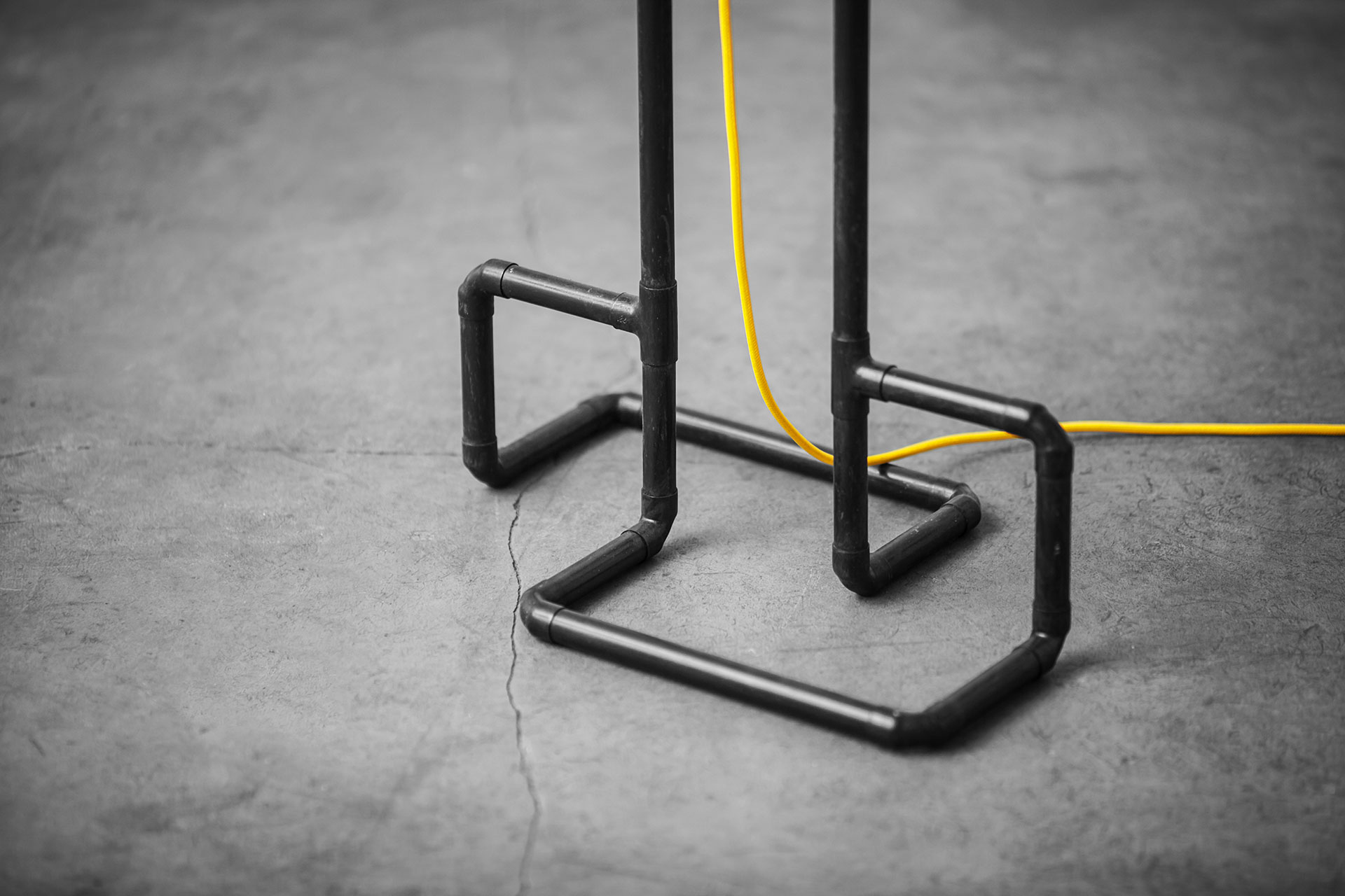 Designer floor lamp detail in black patina with yellow braided cord