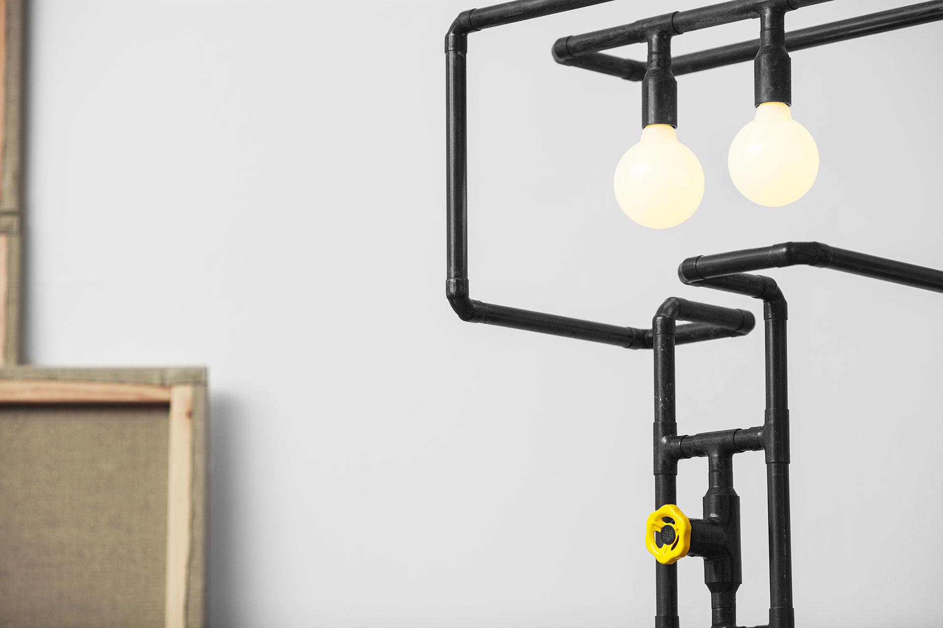 Funny dimmable floor lamp with yellow knob made of copper pipes in natural black patina