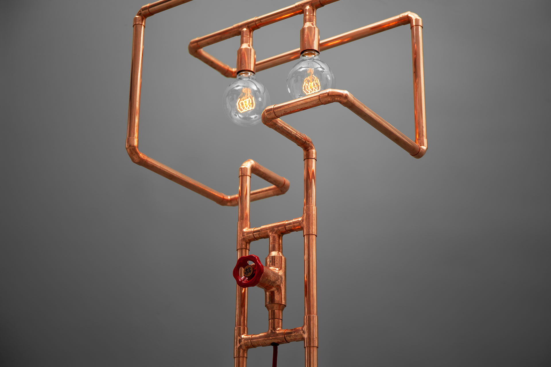 Creative design floor lamp in trendy copper or modern brass inspired by pipes installation