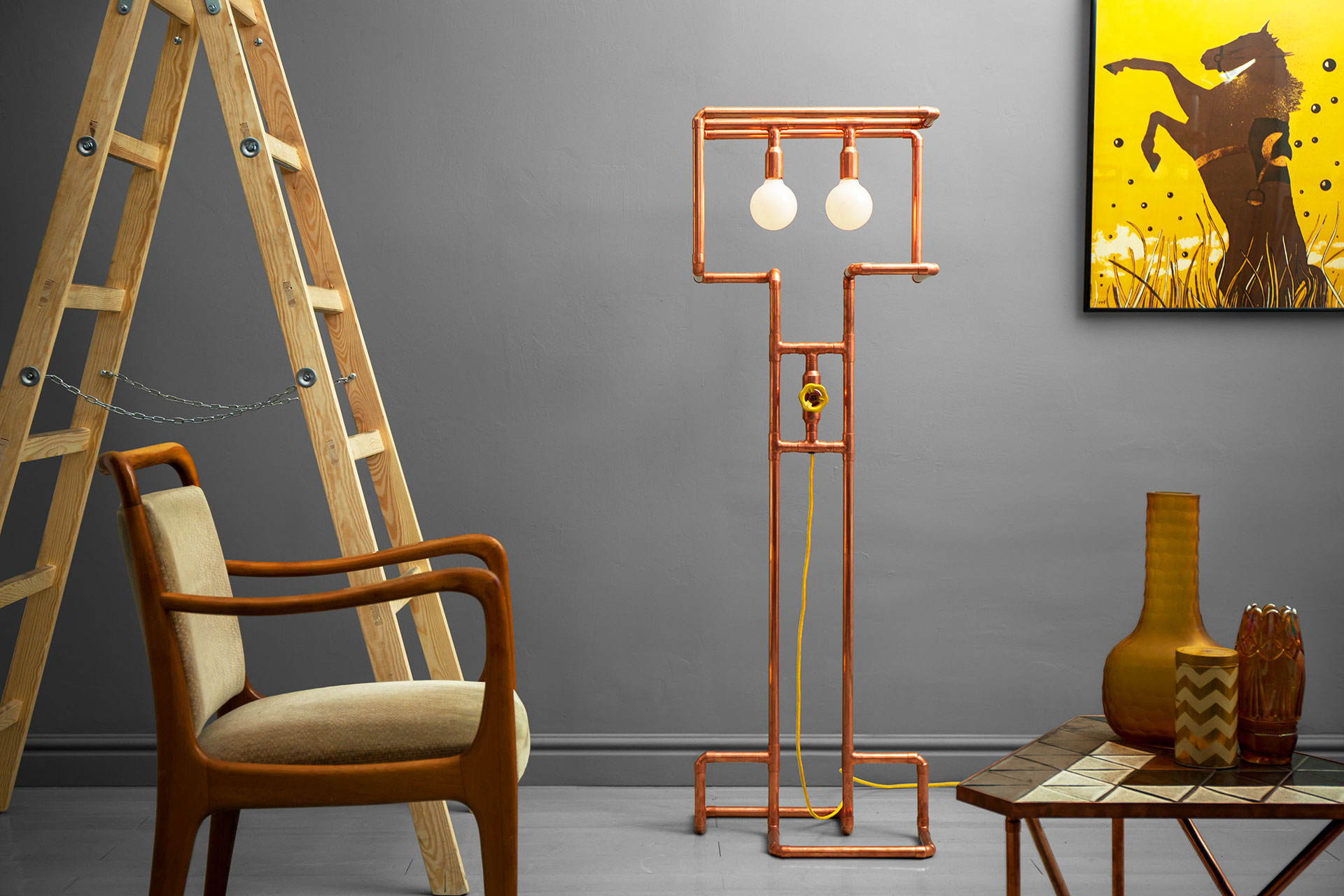Unusual dimmable floor lamp made of trendy copper or modern brass in cozy hipster apartment