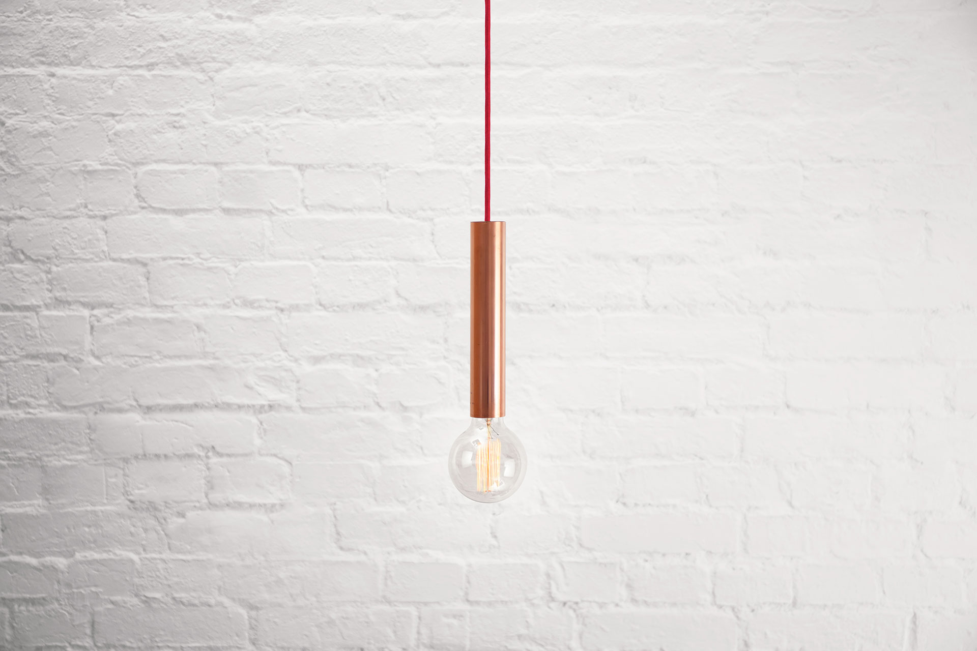 Simple copper pendant lamp in loft style apartment