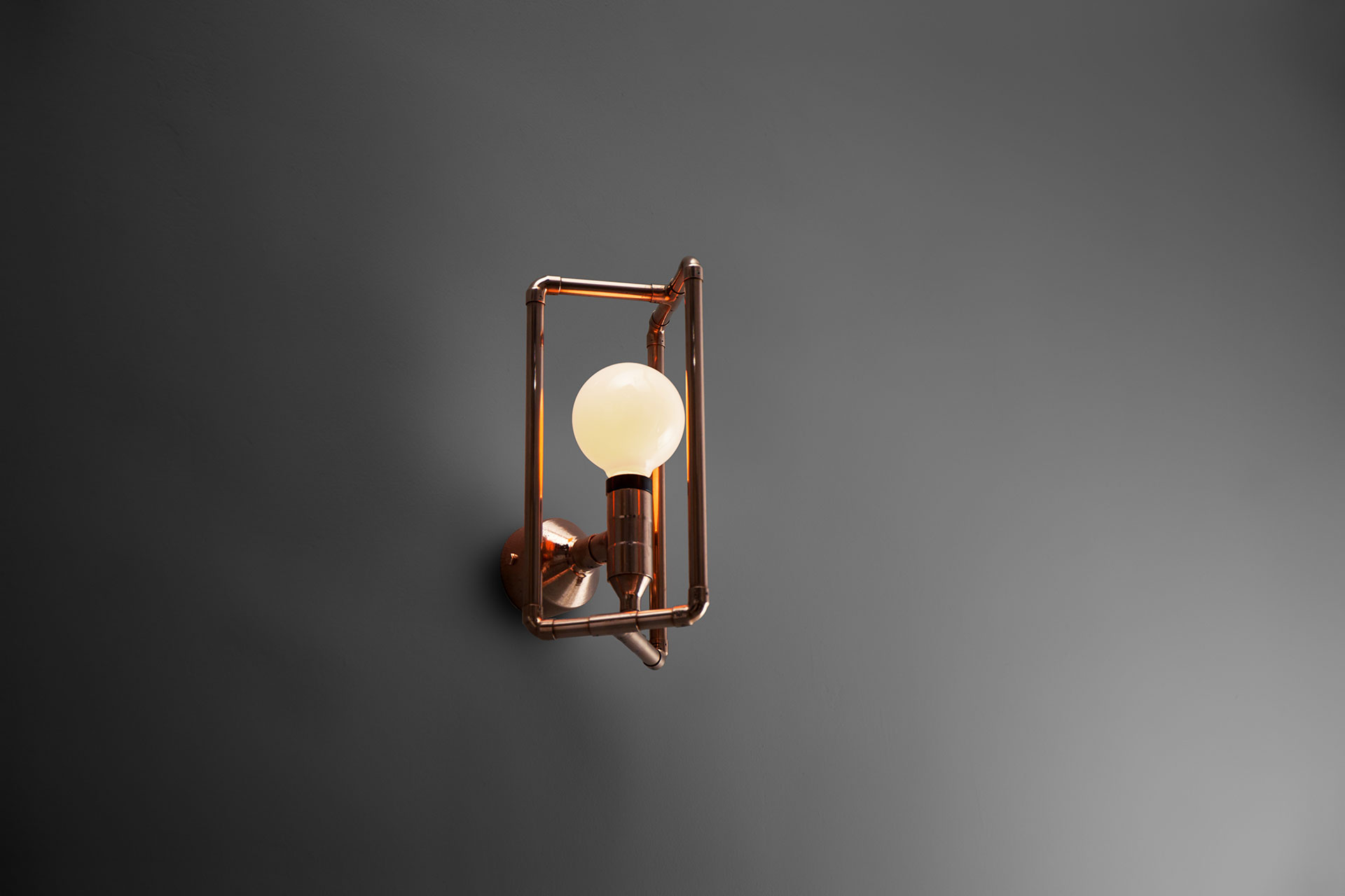 Modern design sconce in brass or copper inspired by industrial style