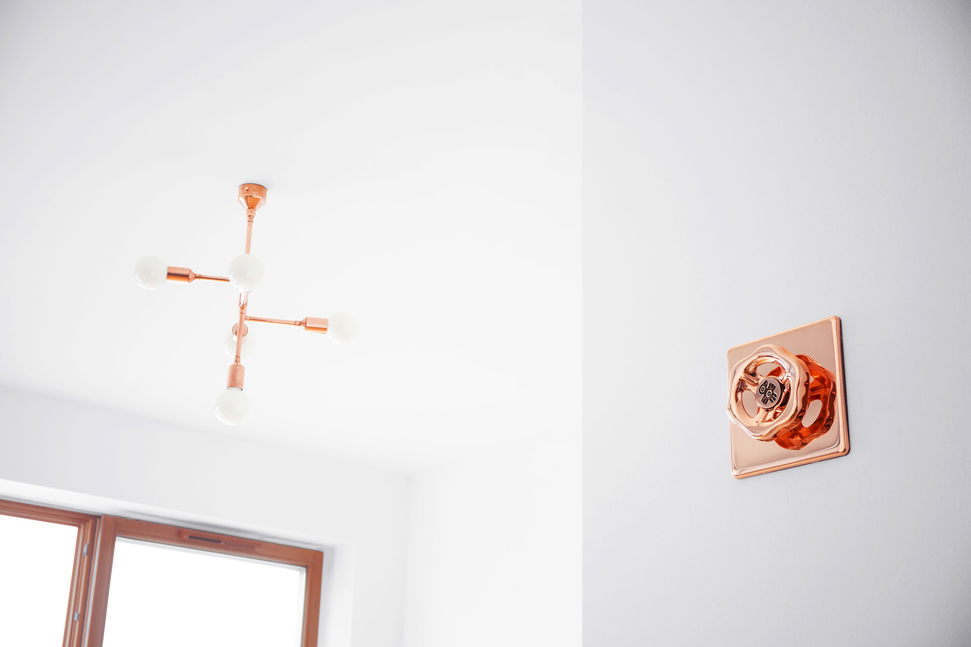 Cool dimmer light switch in trendy copper metal finish in mid-century modern apartment