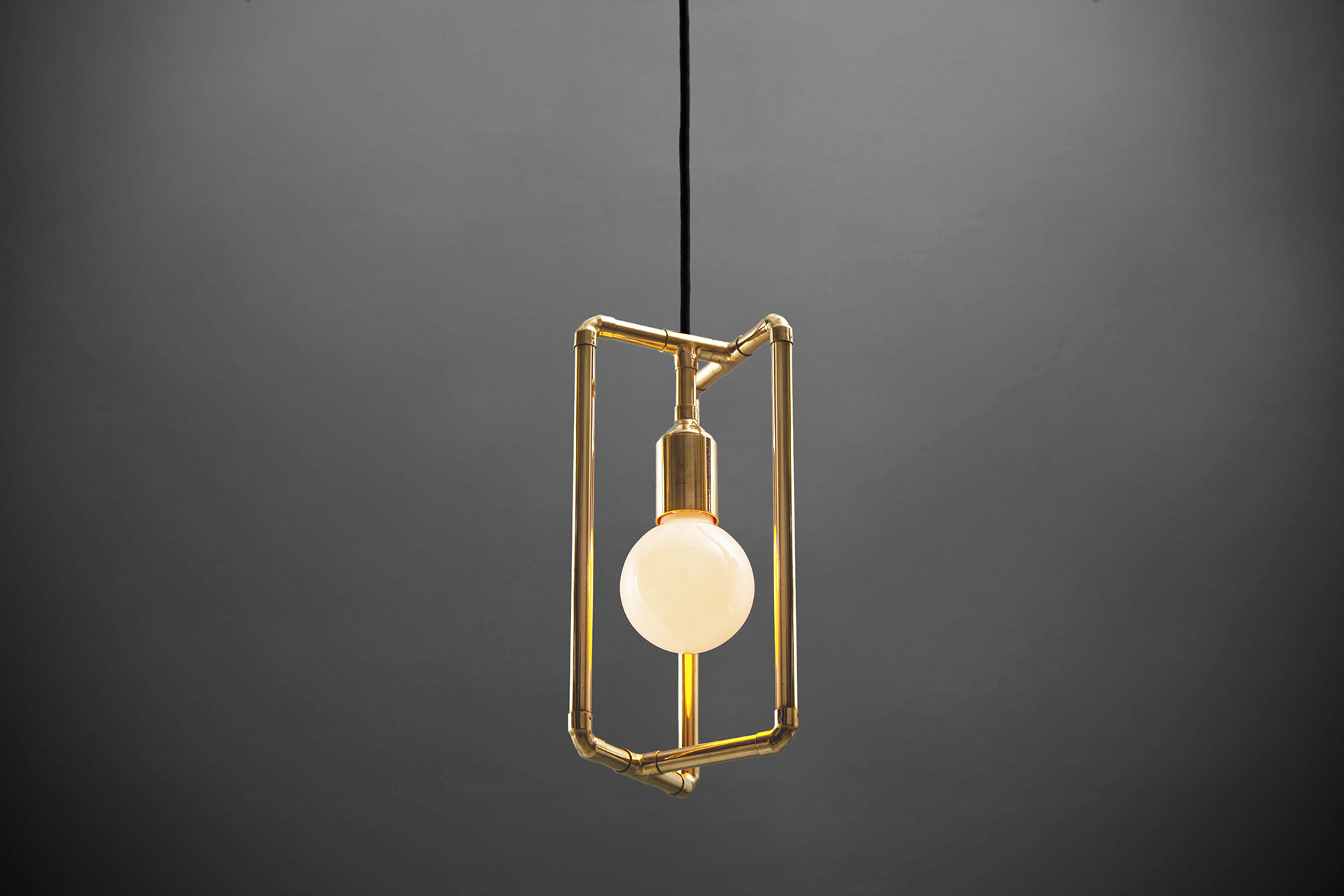 Gold pendant lamp inspired by modern industrial design